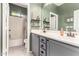 Bathroom featuring double sinks, decorative shelves and a shower/tub combination at 11121 N 165Th Ave, Surprise, AZ 85388