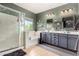 Bathroom boasting double sinks, decorative mirrors, with a walk-in shower and separate tub at 11121 N 165Th Ave, Surprise, AZ 85388