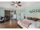 Spacious bedroom featuring wood floors, barn door, and stylish decor at 11121 N 165Th Ave, Surprise, AZ 85388