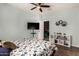 Relaxing bedroom with ceiling fan, a mounted TV and a bookshelf for extra storage at 11121 N 165Th Ave, Surprise, AZ 85388