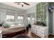 Charming bedroom featuring a bed, white dresser, and leafy decor at 11121 N 165Th Ave, Surprise, AZ 85388