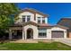 Charming two-story home boasts a welcoming entrance, well-manicured lawn, and an attached two-car garage at 11121 N 165Th Ave, Surprise, AZ 85388