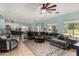 Spacious living room featuring a large sectional sofa, decorative rug, and view to the kitchen at 11121 N 165Th Ave, Surprise, AZ 85388