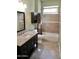 Bathroom showcasing a vanity with countertop, tiled shower, and coordinating fixtures for an elegant aesthetic at 11564 W Mule Deer Ct, Surprise, AZ 85378