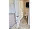 Accessible toilet with grab bars and tiled flooring in a bathroom setting with an open door to a carpeted area at 11564 W Mule Deer Ct, Surprise, AZ 85378