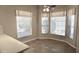 Bright dining area with tile floor and large windows at 11564 W Mule Deer Ct, Surprise, AZ 85378