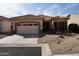 Charming single-story home with a well-manicured yard and a two-car garage on a sunny day at 11564 W Mule Deer Ct, Surprise, AZ 85378