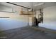 Functional garage interior with storage shelves, a utility closet, and plenty of room for parking and storage at 11564 W Mule Deer Ct, Surprise, AZ 85378