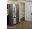 Stainless steel refrigerator and pantry with white shelves at 11564 W Mule Deer Ct, Surprise, AZ 85378