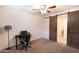 Bedroom featuring a sliding barn door and ceiling fan at 12030 W Louise Ct, Sun City, AZ 85373