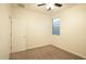 Clean bedroom featuring carpeted floors, bright window, neutral walls and white door at 12030 W Louise Ct, Sun City, AZ 85373