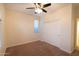 Neutral bedroom with ceiling fan, carpeted floor, and a bright window at 12030 W Louise Ct, Sun City, AZ 85373