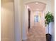 Hallway with tile flooring and an arched entryway leads to other rooms in the house at 12030 W Louise Ct, Sun City, AZ 85373