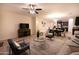 Open-concept living room and kitchen with tile flooring, recessed lighting and ceiling fan at 12030 W Louise Ct, Sun City, AZ 85373