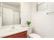 Bright bathroom boasts a tiled shower and bath combination, wooden cabinets and a large mirror at 12711 W Lowden Rd, Peoria, AZ 85383