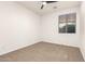 Empty bedroom with ceiling fan, window, and carpeted floor at 12711 W Lowden Rd, Peoria, AZ 85383