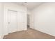 Bright bedroom features neutral carpet, sliding closet doors and a doorway leading to the rest of the home at 12711 W Lowden Rd, Peoria, AZ 85383