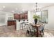 Cozy dining area with a modern chandelier and seating for six, adjacent to the kitchen with a breakfast bar at 12711 W Lowden Rd, Peoria, AZ 85383