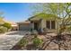 Charming single-story home with a well-maintained front yard and covered porch, featuring a two-car garage at 12711 W Lowden Rd, Peoria, AZ 85383