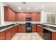 Functional kitchen featuring extensive cabinetry, black appliances, and a convenient layout for cooking at 12711 W Lowden Rd, Peoria, AZ 85383