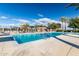 A community pool surrounded by palm trees and ample seating at 12711 W Lowden Rd, Peoria, AZ 85383