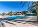 Community swimming pool with blue tiles and lane markers, surrounded by palm trees and seating at 12711 W Lowden Rd, Peoria, AZ 85383