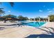 Community pool featuring lounge chairs, umbrellas, and desert landscaping on a sunny day at 12711 W Lowden Rd, Peoria, AZ 85383