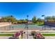 Tennis court surrounded by landscaping features night lighting and a well-maintained surface at 12711 W Lowden Rd, Peoria, AZ 85383