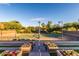 Well-maintained tennis court is surrounded by flowers and is accessible by stairs at 12711 W Lowden Rd, Peoria, AZ 85383