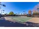 Several outdoor tennis courts with lighting feature well-maintained green playing surfaces at 12711 W Lowden Rd, Peoria, AZ 85383