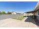 Grassy backyard with covered patio, barbecue and fire pit with gray brick perimeter wall at 15218 N 37Th Ave, Phoenix, AZ 85053