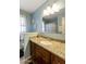 Bathroom vanity with granite countertop, under-mount sink, and framed mirror with decorative lights at 15218 N 37Th Ave, Phoenix, AZ 85053