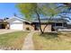 Charming home with a well-manicured lawn, brick accents, and inviting walkway to the front door at 15218 N 37Th Ave, Phoenix, AZ 85053