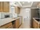 Well-lit kitchen featuring granite countertops and stainless steel appliances and wood cabinets at 15218 N 37Th Ave, Phoenix, AZ 85053