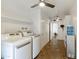 Spacious laundry room includes appliances, ample storage, ceiling fan and doorway at 15218 N 37Th Ave, Phoenix, AZ 85053