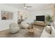 Modern living room featuring neutral colors, a stylish media center, and views into the dining area at 15218 N 37Th Ave, Phoenix, AZ 85053