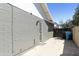 Side yard features brick wall, gravel, storage containers, and door to the main house at 15218 N 37Th Ave, Phoenix, AZ 85053