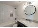 Modern bathroom with subway tile shower, stylish vanity, and round mirror at 154 W 5Th St # 157, Tempe, AZ 85281