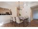 Contemporary dining area featuring a modern chandelier and adjacent kitchen view at 154 W 5Th St # 157, Tempe, AZ 85281