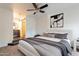 Serene main bedroom with a ceiling fan and ensuite bath featuring a barn door at 154 W 5Th St # 157, Tempe, AZ 85281