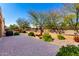 Brick paved patio with desert landscaping, grill, and partial view of adjacent hillside at 16390 W Sheila Ln, Goodyear, AZ 85395