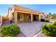 A covered patio leads to a brick paved yard, with desert landscaping at 16390 W Sheila Ln, Goodyear, AZ 85395