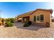 Charming backyard with gravel landscaping, a covered patio, and a well-maintained exterior at 16390 W Sheila Ln, Goodyear, AZ 85395