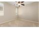 Neutral bedroom with a ceiling fan and plantation shutters and carpeted flooring at 16390 W Sheila Ln, Goodyear, AZ 85395