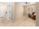 Neutral bonus room with tile flooring, ceiling fan, and large window with white shutters at 16390 W Sheila Ln, Goodyear, AZ 85395