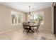 Bright dining room with a round table set beneath a pendant light fixture and shuttered windows at 16390 W Sheila Ln, Goodyear, AZ 85395