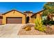 Inviting single-story home boasting desert landscaping, a two-car garage, and tasteful architectural details at 16390 W Sheila Ln, Goodyear, AZ 85395