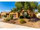 Inviting home with desert landscaping, mature trees, and a well-manicured lawn at 16390 W Sheila Ln, Goodyear, AZ 85395