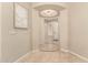 Inviting foyer with tile flooring, a decorative light fixture, and a view of the front door at 16390 W Sheila Ln, Goodyear, AZ 85395