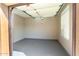 A clean, empty garage with epoxy floor and window providing ample natural light at 16390 W Sheila Ln, Goodyear, AZ 85395